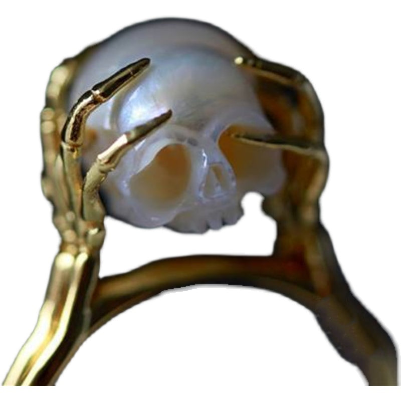 Hand Carved Skull ring resting in sterling silver Hands